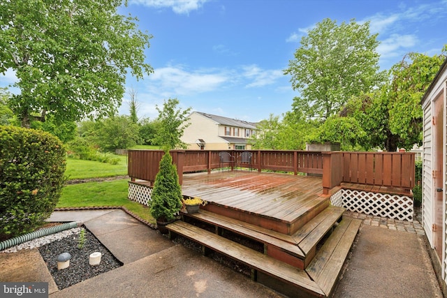 wooden deck featuring a lawn