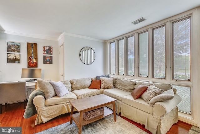 living area with crown molding and wood finished floors