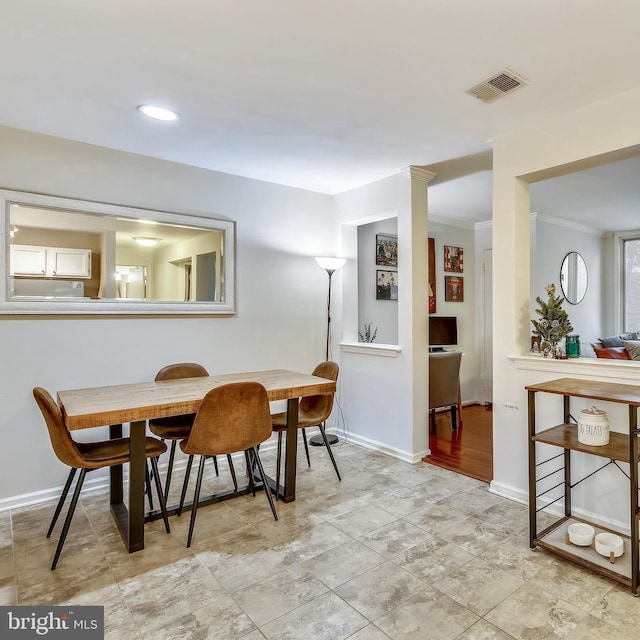 dining area featuring baseboards and ornamental molding
