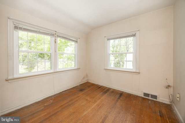 spare room with hardwood / wood-style flooring and baseboards
