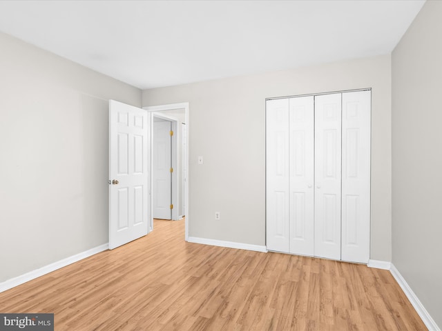 206 Water Fountain Ct Unit 201, Glen Burnie, MD 21060 - unfurnished bedroom with light wood-style flooring, baseboards, and a closet
