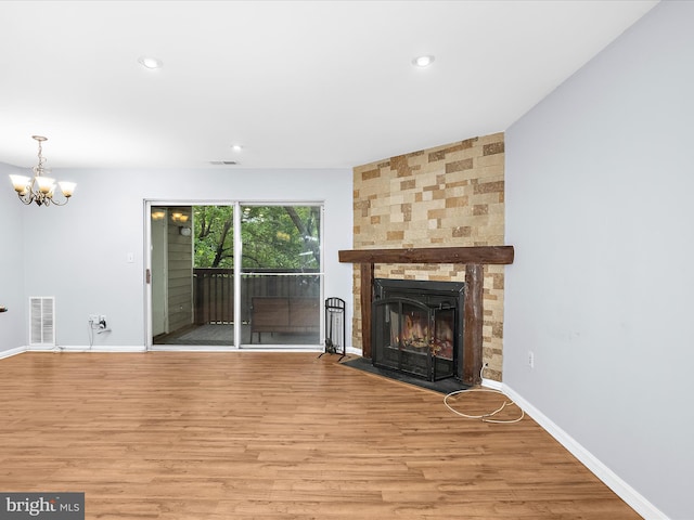 206 Water Fountain Ct Unit 201, Glen Burnie, MD 21060 - unfurnished living room with a chandelier, wood finished floors, baseboards, recessed lighting, and a large fireplace