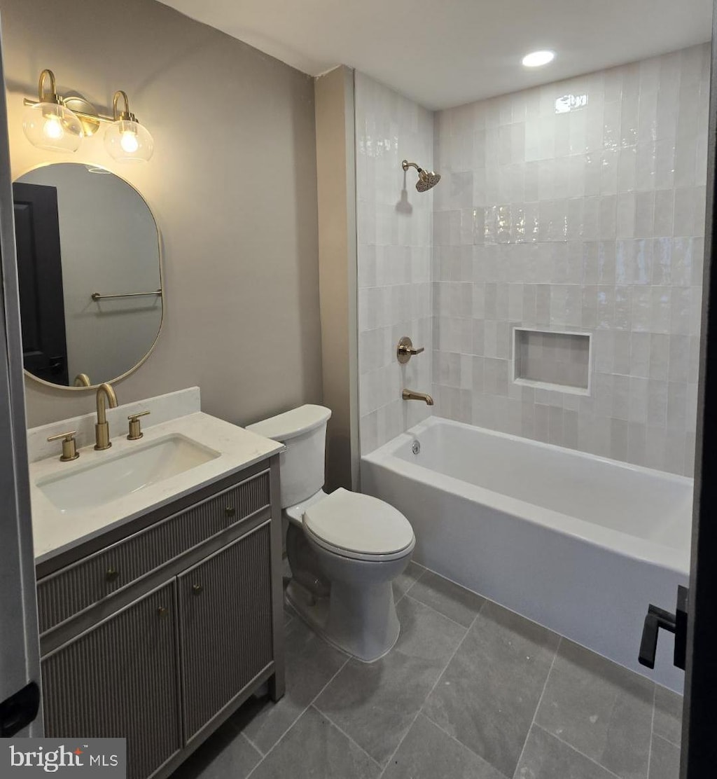 bathroom with tile patterned flooring, toilet, vanity, shower / washtub combination, and recessed lighting