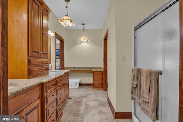 bathroom featuring double vanity and baseboards