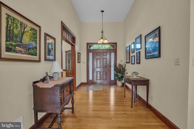 foyer with light wood-type flooring and baseboards