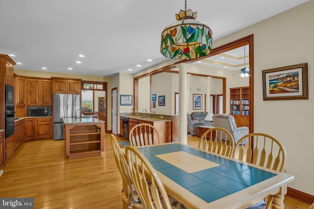 dining room featuring recessed lighting, light wood-style flooring, ornate columns, and a ceiling fan