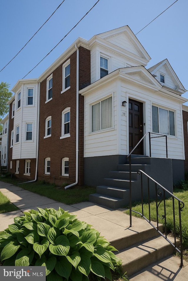 view of front of home featuring brick siding