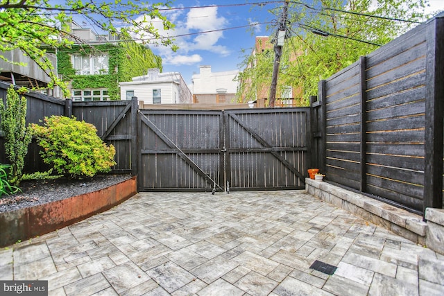 1314 Wallach Pl NW, Washington, DC 20009 - gate with a patio area and a fenced backyard