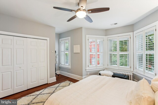 1314 Wallach Pl NW, Washington, DC 20009 - bedroom featuring baseboards, dark wood-type flooring, radiator, ceiling fan, and a closet