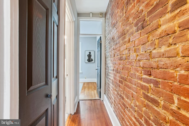 1314 Wallach Pl NW, Washington, DC 20009 - corridor featuring brick wall, hardwood / wood-style floors, and baseboards