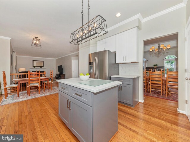 9034 Allington Manor Cir W, Frederick, MD 21703 - kitchen featuring gray cabinetry, stainless steel fridge with ice dispenser, a chandelier, light wood-style floors, and crown molding