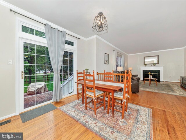 9034 Allington Manor Cir W, Frederick, MD 21703 - dining space featuring ornamental molding, wood finished floors, a fireplace, and baseboards