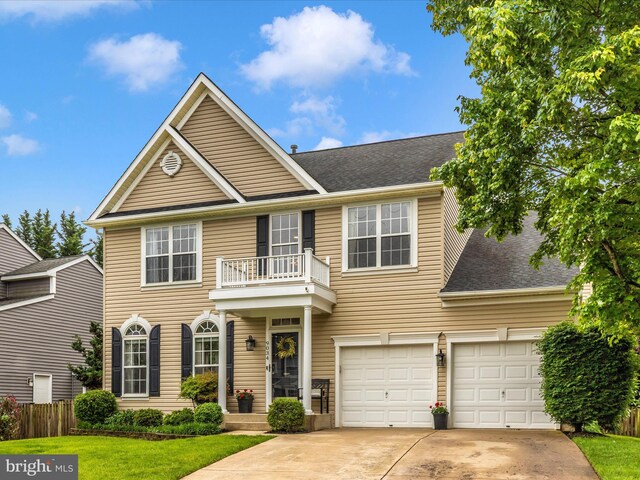 9034 Allington Manor Cir W, Frederick, MD 21703 - colonial-style house featuring a balcony, concrete driveway, roof with shingles, a garage, and fence