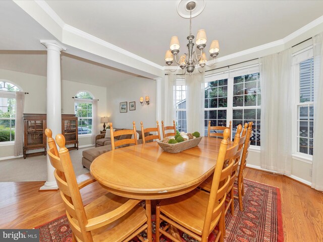 9034 Allington Manor Cir W, Frederick, MD 21703 - dining space featuring ornate columns, light wood finished floors, a chandelier, and ornamental molding