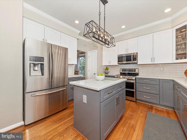 9034 Allington Manor Cir W, Frederick, MD 21703 - kitchen featuring appliances with stainless steel finishes, gray cabinetry, ornamental molding, a kitchen island, and a chandelier