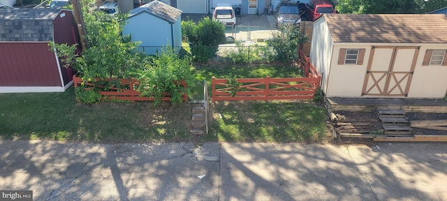 view of yard with a storage unit and an outbuilding