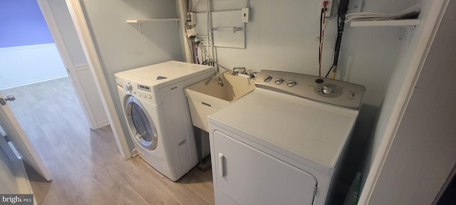 laundry area featuring light wood-style flooring and washer and dryer