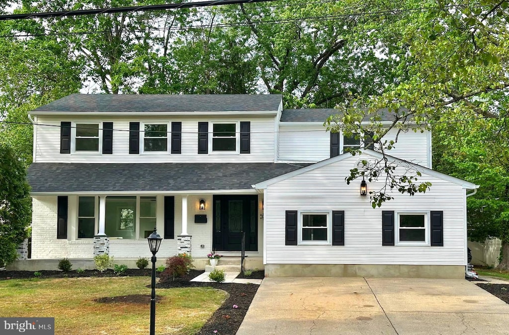 421 Doral Dr, Cherry Hill, NJ 08003 - view of front facade featuring a porch, a chimney, roof with shingles, and driveway