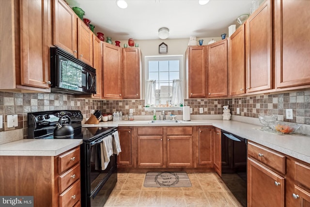 307 Obelisk Ln, Middletown, DE 19709 - kitchen with black appliances, a sink, plenty of natural light, and light countertops