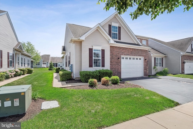 307 Obelisk Ln, Middletown, DE 19709 - view of front of house with asphalt driveway, a garage, a front lawn, and brick siding
