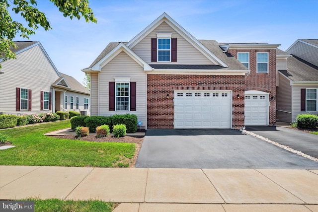 307 Obelisk Ln, Middletown, DE 19709 - traditional-style house featuring driveway, a front lawn, brick siding, and roof with shingles