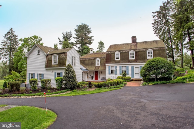 3864 Spring Valley Rd, Doylestown, PA 18902 - colonial inspired home featuring a gambrel roof, a chimney, and asphalt driveway