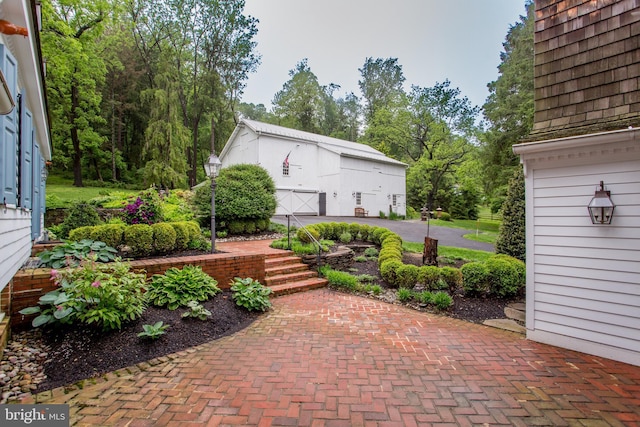 3864 Spring Valley Rd, Doylestown, PA 18902 - view of patio featuring a garage, a barn, and an outdoor structure