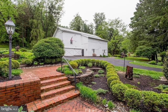 3864 Spring Valley Rd, Doylestown, PA 18902 - view of front facade featuring a garage, a barn, an outbuilding, and view of wooded area
