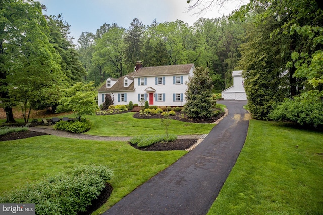 3864 Spring Valley Rd, Doylestown, PA 18902 - view of front of property featuring an outbuilding, a chimney, a front lawn, and a view of trees