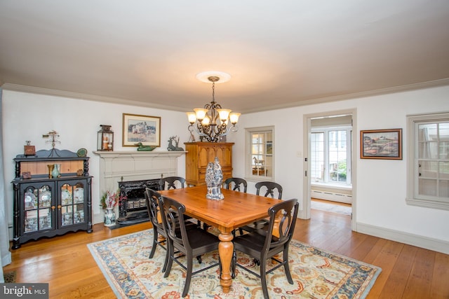 3864 Spring Valley Rd, Doylestown, PA 18902 - dining room featuring a chandelier, crown molding, light wood-style floors, a baseboard heating unit, and a high end fireplace