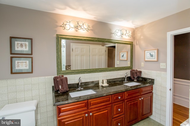 3864 Spring Valley Rd, Doylestown, PA 18902 - full bath with tile walls, double vanity, a wainscoted wall, and toilet