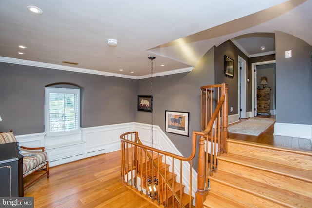 3864 Spring Valley Rd, Doylestown, PA 18902 - stairway with arched walkways, crown molding, wood finished floors, a wainscoted wall, and recessed lighting