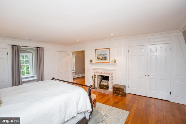 3864 Spring Valley Rd, Doylestown, PA 18902 - bedroom with ornamental molding, light wood finished floors, a closet, baseboard heating, and a fireplace