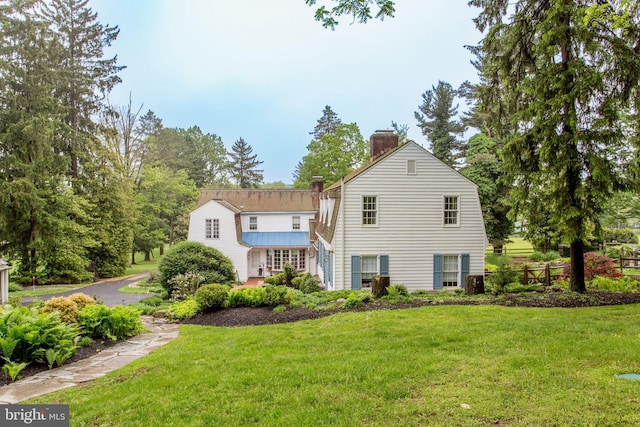 3864 Spring Valley Rd, Doylestown, PA 18902 - rear view of property featuring a chimney, a gambrel roof, and a yard