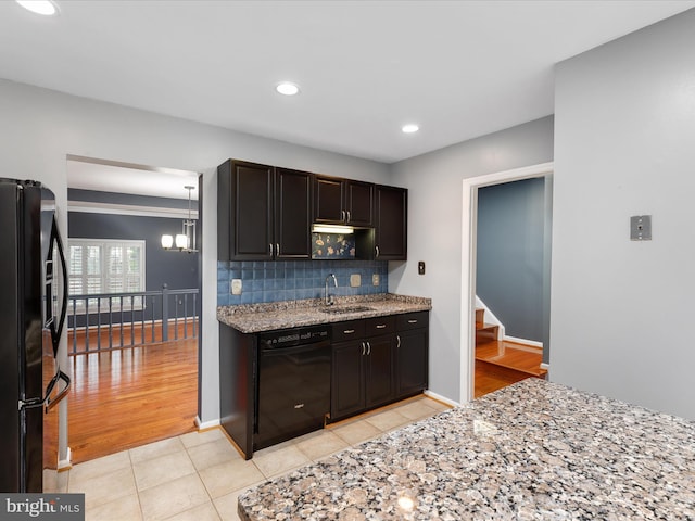 6521 Kemper Lakes Ct, Alexandria, VA 22312 - kitchen featuring black appliances, a sink, light tile patterned flooring, backsplash, and light stone countertops