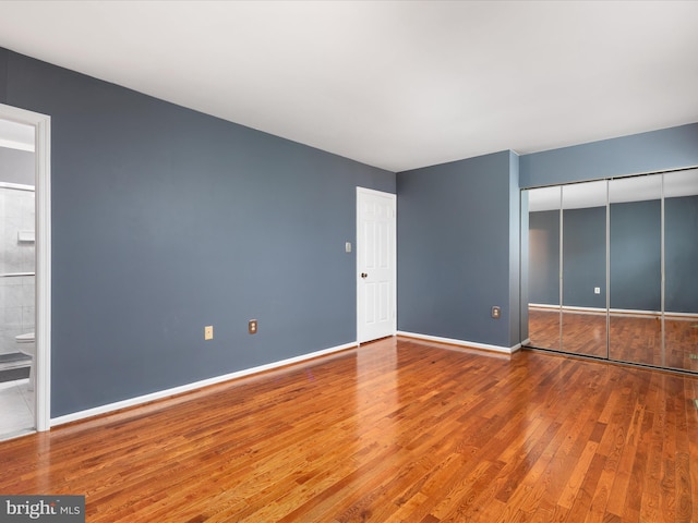 6521 Kemper Lakes Ct, Alexandria, VA 22312 - unfurnished bedroom featuring wood finished floors, baseboards, a closet, and connected bathroom