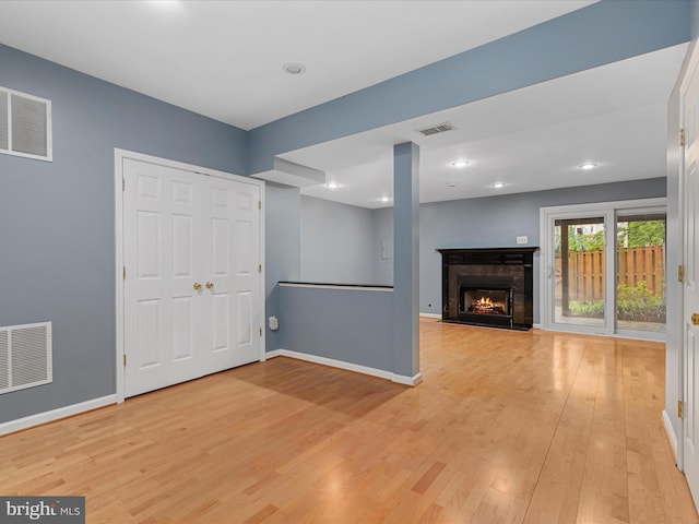 6521 Kemper Lakes Ct, Alexandria, VA 22312 - unfurnished living room featuring light wood-style floors, a warm lit fireplace, baseboards, and recessed lighting