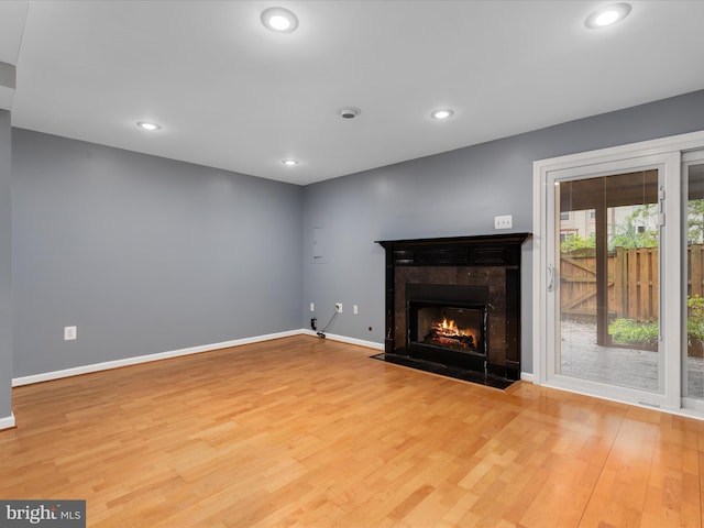 6521 Kemper Lakes Ct, Alexandria, VA 22312 - unfurnished living room with wood finished floors, a tile fireplace, baseboards, and recessed lighting