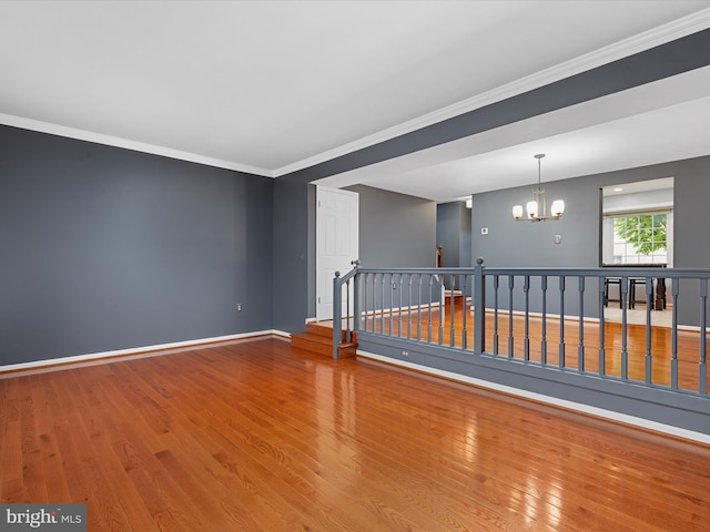 6521 Kemper Lakes Ct, Alexandria, VA 22312 - spare room featuring a chandelier, wood finished floors, baseboards, and ornamental molding
