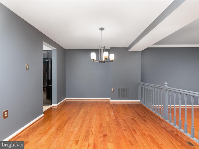 6521 Kemper Lakes Ct, Alexandria, VA 22312 - unfurnished room featuring wood finished floors, a chandelier, and baseboards