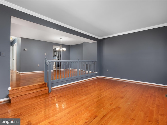 6521 Kemper Lakes Ct, Alexandria, VA 22312 - empty room with a chandelier, wood finished floors, ornamental molding, and baseboards