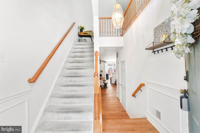 13304 Tivoli Fountain Ct, Germantown, MD 20874 - stairway featuring a high ceiling, a chandelier, and wood finished floors