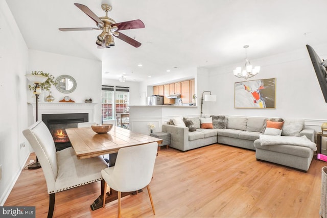 13304 Tivoli Fountain Ct, Germantown, MD 20874 - living area featuring a glass covered fireplace, ceiling fan, a chandelier, light wood finished floors, and recessed lighting