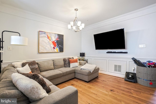 13304 Tivoli Fountain Ct, Germantown, MD 20874 - living area with a chandelier, ornamental molding, wood finished floors, and wainscoting