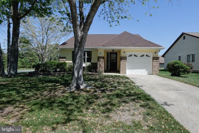 ranch-style home with brick siding, an attached garage, concrete driveway, and a front lawn