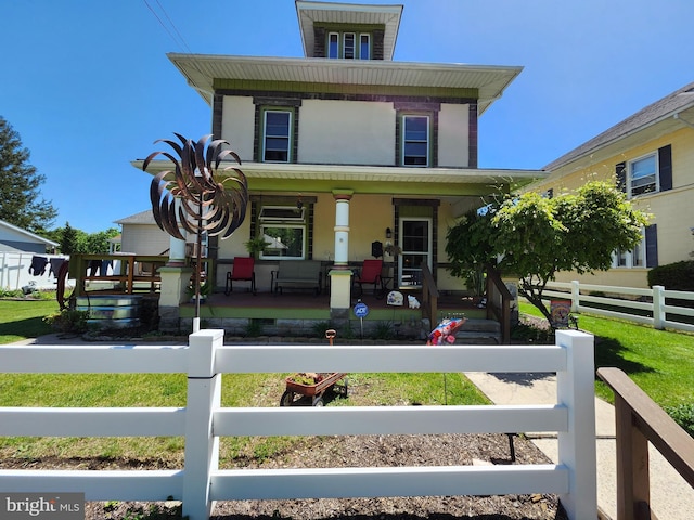 view of front facade featuring a porch, a fenced front yard, and stucco siding