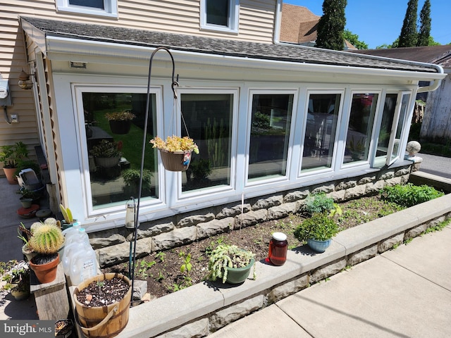 view of side of property featuring a shingled roof