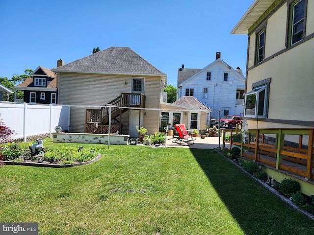 back of property featuring a patio area and stairway