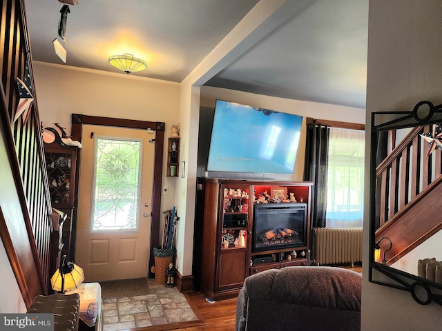 entrance foyer with radiator and wood finished floors
