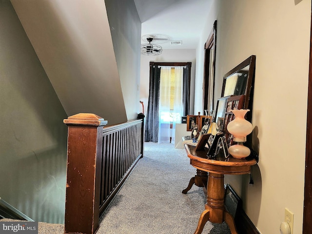 hall featuring carpet flooring